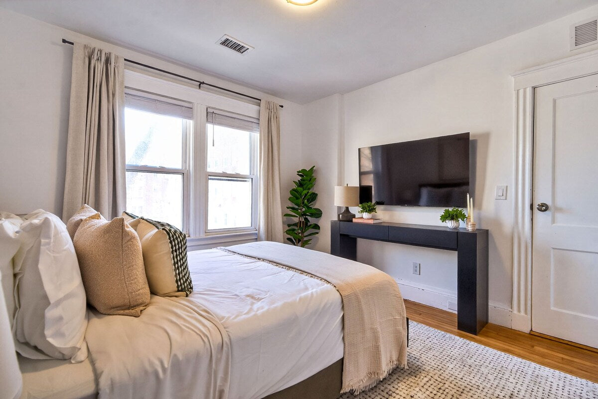 Luxury Cambridge Hideaway — bedroom with mounted TV