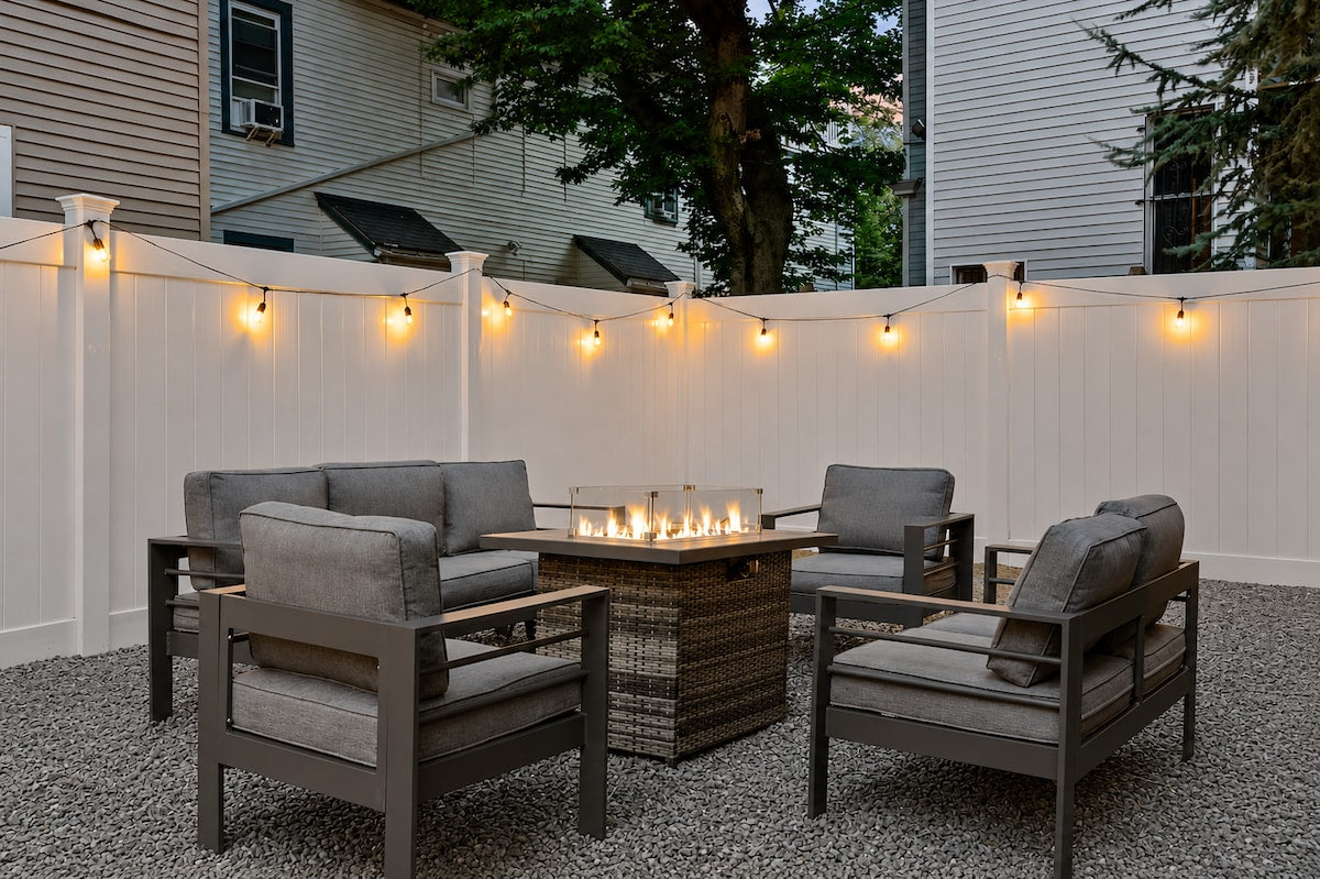 Cambridge apartment — outdoor patio with string lights and fire pit by Elite Host Partners